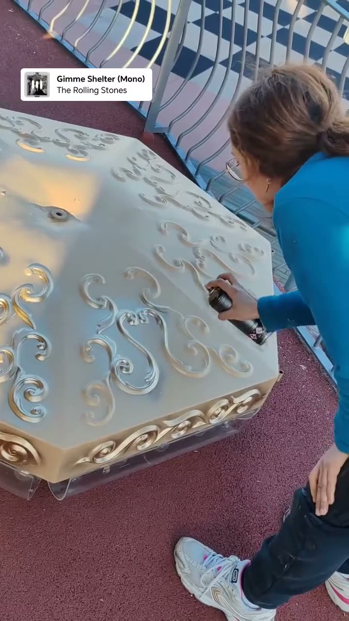 Varnishing the gilded cresting